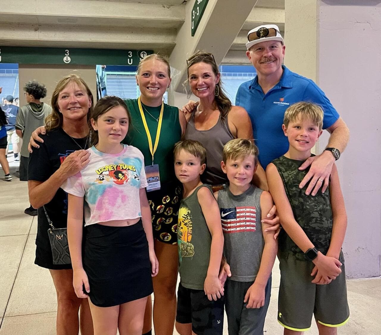 Emma posing with her family at a competition stadium